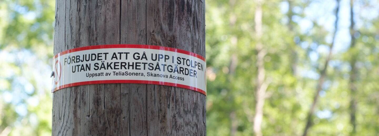 Electric pole with warning sign