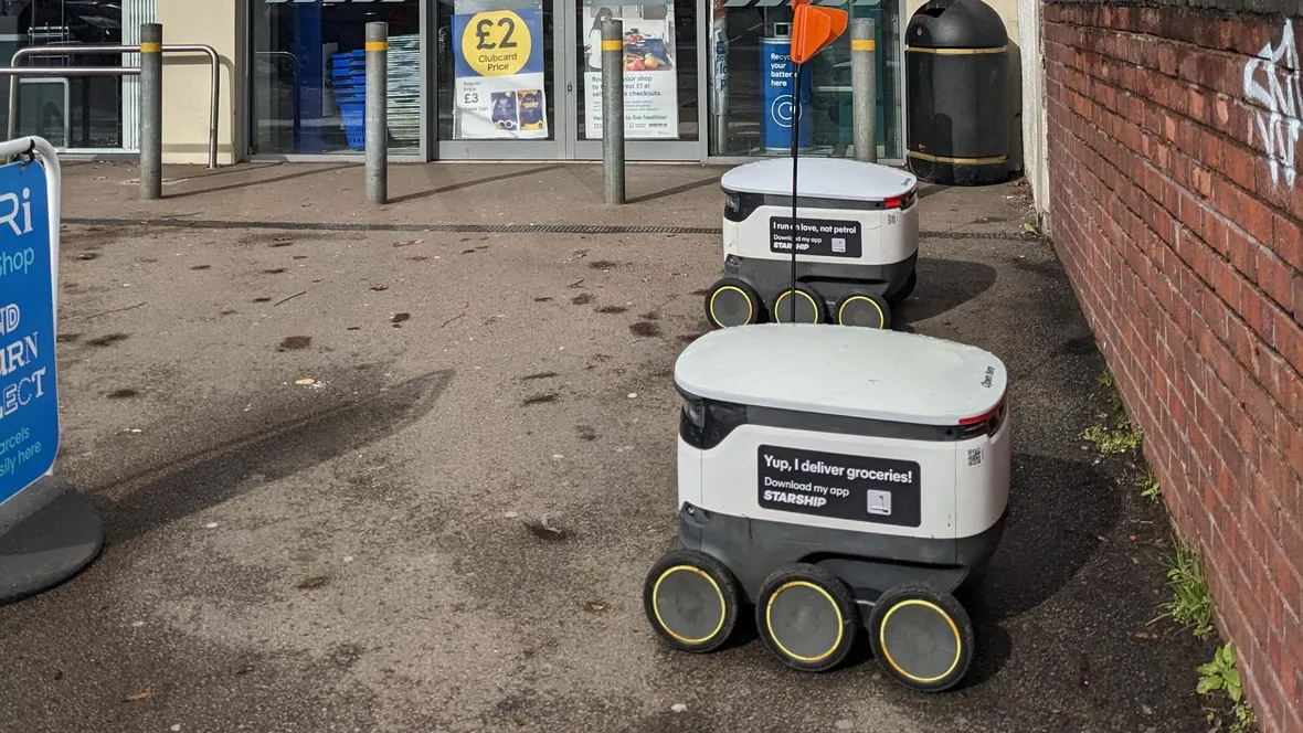 Robots parked outside a store.