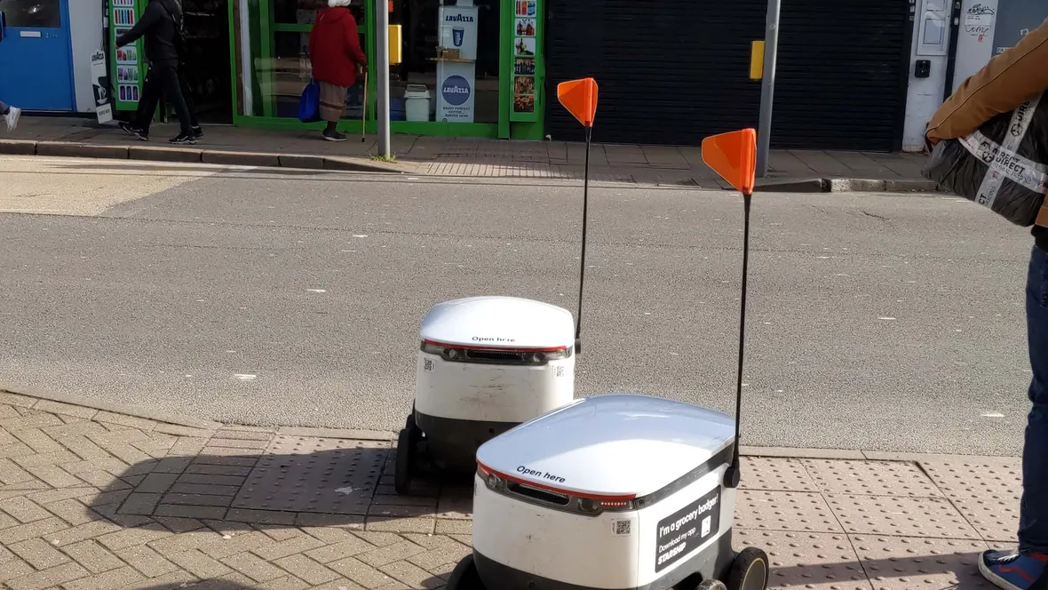 Robots parked outside a store.