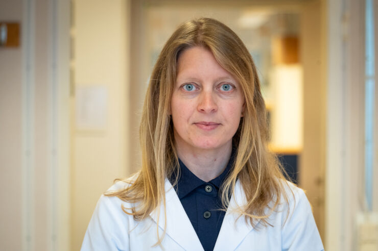 Headshot of woman in a white lab coat.