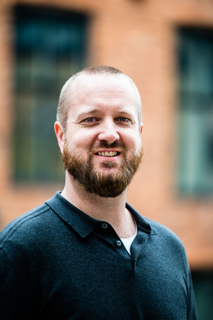 Headshot of a man outdoors.