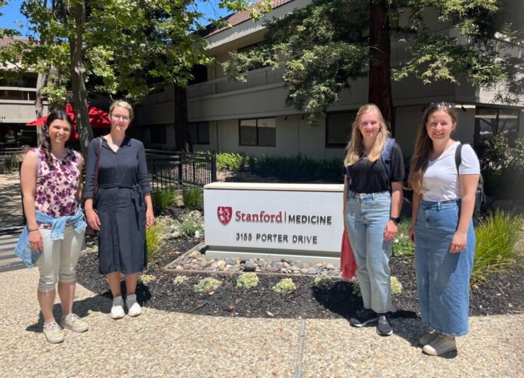 A few Forum members in front of the sign to Sharon Petteri's lab