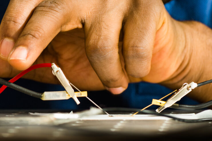 Hands doing electronic work