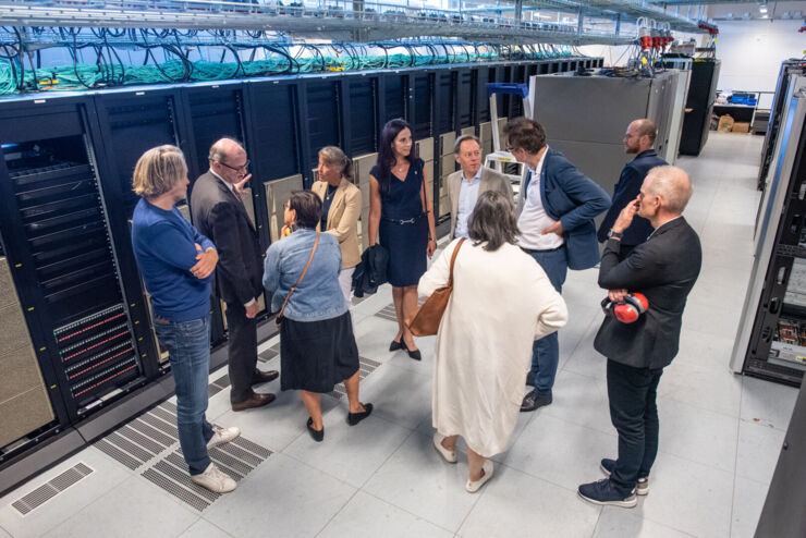 A group of people standing in a server hall.