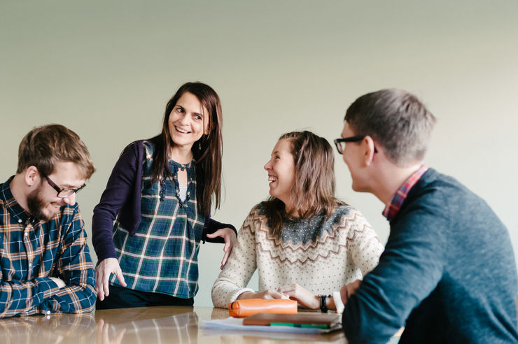  A teacher smiles at a group of students.