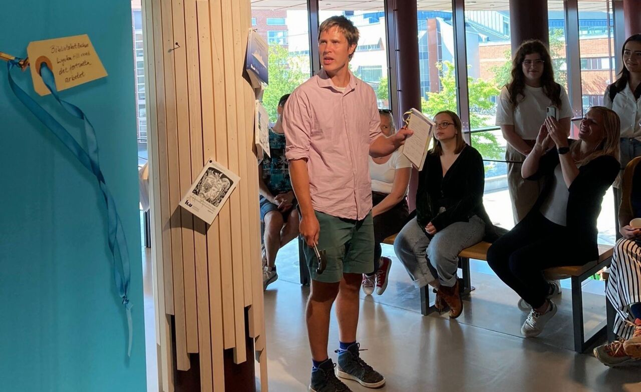 A man who is about to become doctor presenting his doctoral thesis.
