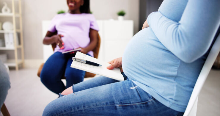 Pregnant women in a room.