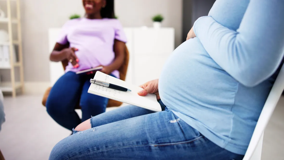Pregnant women in a room.