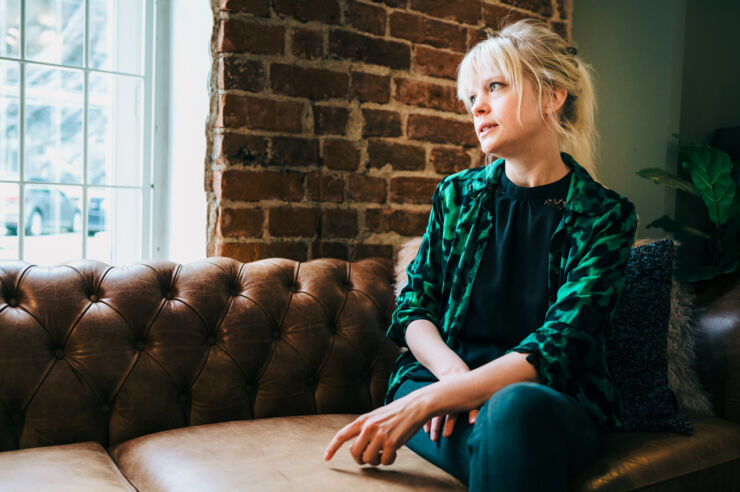 Person (Agnes Larsson) by a window.