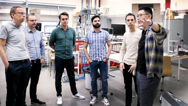 Six men in  a lab.