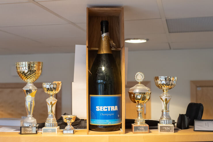 A bottle of champagne with Sectra on its label