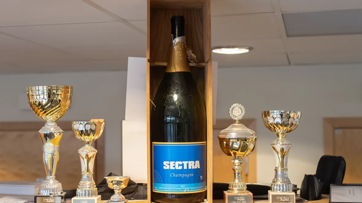 A bottle of champagne with Sectra on its label