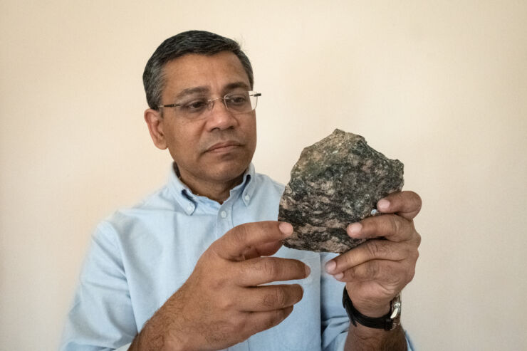 Headshot of man holding an archeological artefact.