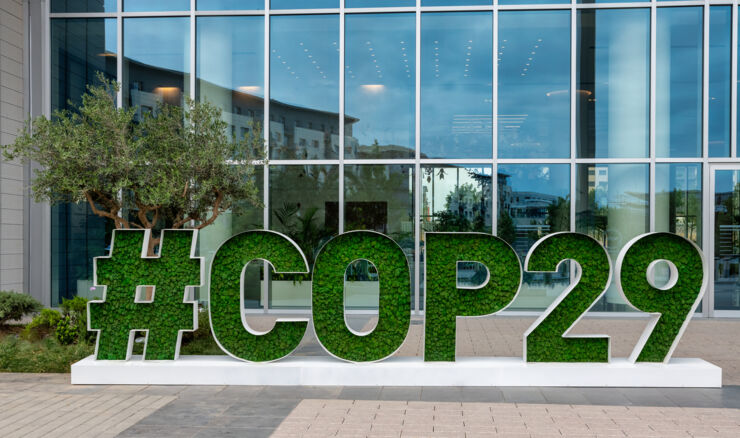 A sign with COP29 outside a building.