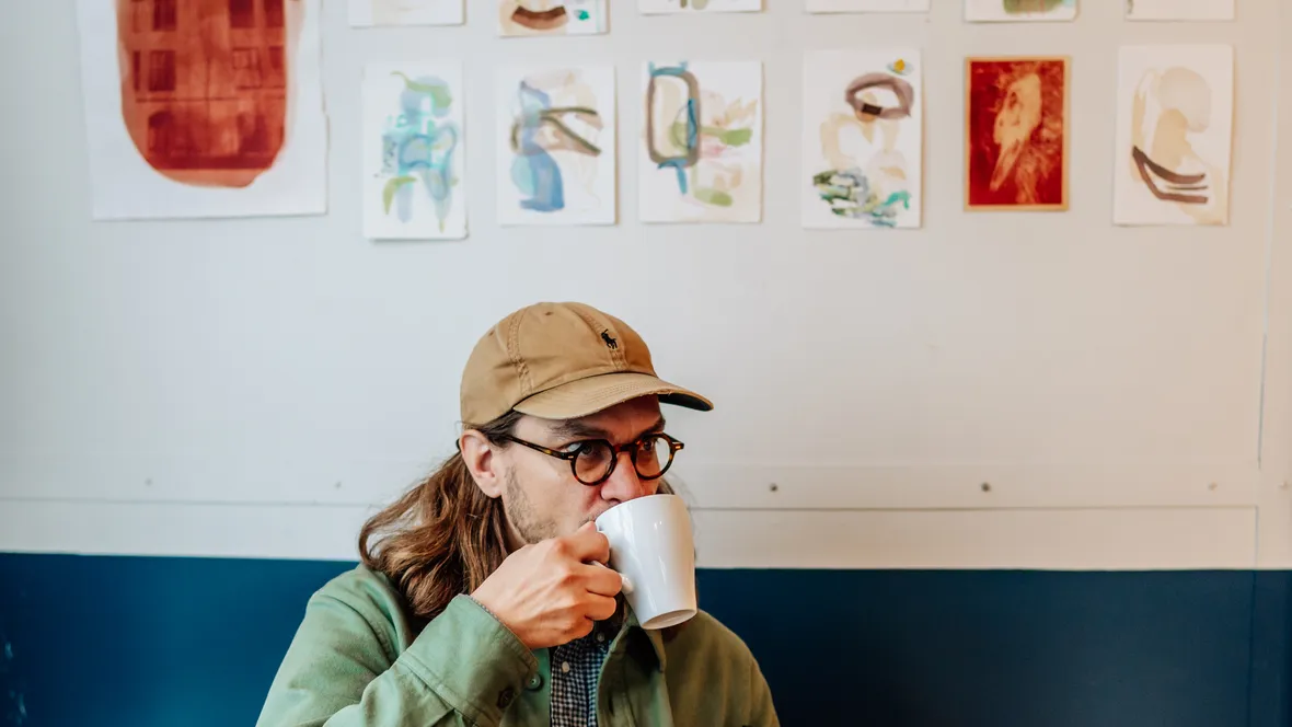 A person drinking from a mug