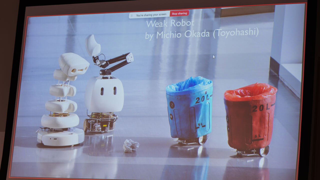 photo of screen of presentation showing image of little robots