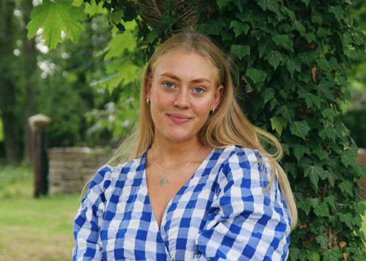 Young blonde woman with a blue and white checkered blouse